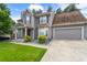 Attractive two-story home with gray siding, lush lawn, mature landscaping, and an attached garage at 4903 Wilkie Nw Way, Acworth, GA 30102