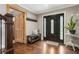 Inviting foyer showcasing hardwood floors, a decorative front door, bench with shoe storage, and staircase at 4903 Wilkie Nw Way, Acworth, GA 30102