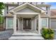 Inviting covered front porch with classic columns and an elegant, decorative glass front door at 4903 Wilkie Nw Way, Acworth, GA 30102