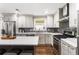 Contemporary kitchen boasting white cabinetry, stainless steel appliances, and a gray subway tile backsplash at 4903 Wilkie Nw Way, Acworth, GA 30102