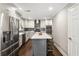 Modern kitchen with stainless steel appliances, island, and dark wood floors at 4903 Wilkie Nw Way, Acworth, GA 30102