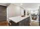 Stylish kitchen island with marble countertops, dark gray cabinets, and seating for three at 4903 Wilkie Nw Way, Acworth, GA 30102