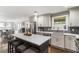 Modern kitchen with an island, white cabinets, stainless steel appliances, and gray backsplash at 4903 Wilkie Nw Way, Acworth, GA 30102