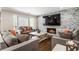 Inviting living room with a fireplace, plush seating, natural light, and hardwood floors at 4903 Wilkie Nw Way, Acworth, GA 30102