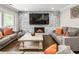 Inviting living room features a stone accent wall, fireplace, and two comfortable gray sofas at 4903 Wilkie Nw Way, Acworth, GA 30102