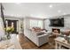Open living room showcases a stone fireplace, hardwood floors, and a decorative front door at 4903 Wilkie Nw Way, Acworth, GA 30102