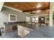 Outdoor kitchen with bar-style seating, stainless sink, custom cabinets, and stone countertops at 4903 Wilkie Nw Way, Acworth, GA 30102