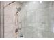 Modern shower with large tile enclosure, rainfall shower head, and stylish fixtures at 4903 Wilkie Nw Way, Acworth, GA 30102