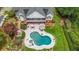 Aerial view of a backyard with a kidney-shaped pool, outdoor seating, and a well-maintained lawn, perfect for relaxation at 750 Old Loganville Road Southwest, Loganville, GA 30052
