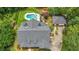 Aerial view of home with pool, detached garage, mature trees and lush landscaping providing privacy in a park-like setting at 750 Old Loganville Road Southwest, Loganville, GA 30052