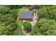 Aerial view of a home with a pool surrounded by lush landscaping and mature trees at 750 Old Loganville Road Southwest, Loganville, GA 30052