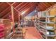 Spacious attic offers ample storage with shelving, boxes, and exposed wooden beams at 750 Old Loganville Road Southwest, Loganville, GA 30052