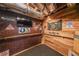 Eclectic basement bar area featuring exposed brick and wood with a dartboard, and TV setup at 750 Old Loganville Road Southwest, Loganville, GA 30052