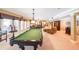 Spacious finished basement featuring a billiard table, seating area, and access to natural light from windows at 750 Old Loganville Road Southwest, Loganville, GA 30052