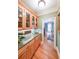 Butler's pantry with granite countertops and wood cabinets leads into a separate dining area at 750 Old Loganville Road Southwest, Loganville, GA 30052