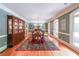 Formal dining room with hardwood floors, a large china cabinet, a dining table, and natural light from multiple windows at 750 Old Loganville Road Southwest, Loganville, GA 30052