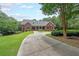 Beautiful brick home with a welcoming front porch and well-manicured lawn and long driveway at 750 Old Loganville Road Southwest, Loganville, GA 30052
