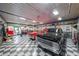 Large garage featuring a checkered floor, vintage cars, and classic automotive memorabilia at 750 Old Loganville Road Southwest, Loganville, GA 30052