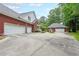 Spacious three-car garage and detached garage with a large driveway and surrounding greenery at 750 Old Loganville Road Southwest, Loganville, GA 30052