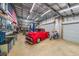 Inside the spacious garage, a red truck and a motorcycle highlight the ample workspace at 750 Old Loganville Road Southwest, Loganville, GA 30052