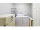 Bright laundry room with washer, dryer, and additional storage space at 750 Old Loganville Road Southwest, Loganville, GA 30052