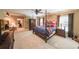 Nautical themed primary bedroom with a large four-poster bed and sitting area at 750 Old Loganville Road Southwest, Loganville, GA 30052