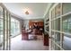 Well-lit home office with built-in shelving, a large desk, and French doors, providing a professional workspace at 750 Old Loganville Road Southwest, Loganville, GA 30052