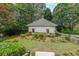 Charming outbuilding with manicured landscaping and a traditional fence at 750 Old Loganville Road Southwest, Loganville, GA 30052