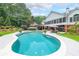Expansive backyard pool and patio area set against a backdrop of lush greenery at 750 Old Loganville Road Southwest, Loganville, GA 30052