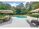 Stunning backyard pool with elegant lounge chairs and shaded dining for outdoor relaxation and entertaining at 750 Old Loganville Road Southwest, Loganville, GA 30052