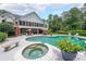Beautiful backyard pool and hot tub with adjacent screened porch on a two-story traditional home at 750 Old Loganville Road Southwest, Loganville, GA 30052