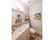 Elegant powder room features a marble countertop vanity and decorative wall art at 750 Old Loganville Road Southwest, Loganville, GA 30052