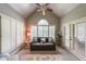 Sun-drenched sitting room with vaulted ceiling, white shutters, and comfortable seating at 750 Old Loganville Road Southwest, Loganville, GA 30052