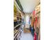 Organized walk-in closet with built-in shelving for shoes and clothing storage, illuminated by a natural light window at 750 Old Loganville Road Southwest, Loganville, GA 30052