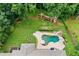 Aerial view of home with pool, play area, spacious lawns and deck at 217 Heritage Town Pkwy, Canton, GA 30115