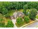Aerial view showcasing a well-maintained property with mature trees, pool, play area, and inviting curb appeal at 217 Heritage Town Pkwy, Canton, GA 30115