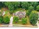 Beautifully landscaped property with mature trees, inviting front porch, and a spacious backyard with pool and play area at 217 Heritage Town Pkwy, Canton, GA 30115