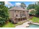Exterior view of a backyard with pool, deck, patio, and large grassy area at 217 Heritage Town Pkwy, Canton, GA 30115
