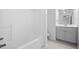 Bright bathroom with shower/tub and updated vanity with a view of the commode at 217 Heritage Town Pkwy, Canton, GA 30115