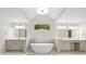 Primary bathroom with double sink vanity, large mirror, and standalone bathtub at 217 Heritage Town Pkwy, Canton, GA 30115