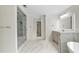 Primary bathroom with walk-in shower, tile floor, double sink vanity with large mirror, and standalone tub at 217 Heritage Town Pkwy, Canton, GA 30115