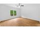 Bright bedroom with hardwood floors, ceiling fan, large window with backyard view and white trim at 217 Heritage Town Pkwy, Canton, GA 30115