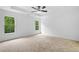 Spacious bedroom featuring neutral carpet, tray ceiling, and abundant natural light at 217 Heritage Town Pkwy, Canton, GA 30115