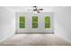 A roomy bedroom with three large windows and neutral carpeting at 217 Heritage Town Pkwy, Canton, GA 30115
