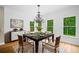 Bright dining room features a modern chandelier, hardwood floors, and abundant natural light with peaceful view at 217 Heritage Town Pkwy, Canton, GA 30115