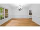 Formal dining room with hardwood floors, chandelier, and built-in cabinets at 217 Heritage Town Pkwy, Canton, GA 30115