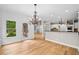Dining area featuring hardwood floors with access to the kitchen and outdoor patio at 217 Heritage Town Pkwy, Canton, GA 30115