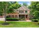 Beautiful two-story home with manicured lawn and inviting front porch at 217 Heritage Town Pkwy, Canton, GA 30115