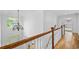 Elegant hallway with hardwood floors, a chandelier, and wooden banister at 217 Heritage Town Pkwy, Canton, GA 30115