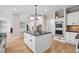Open-concept kitchen features a large island with granite countertops and stainless appliances at 217 Heritage Town Pkwy, Canton, GA 30115